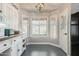 Kitchen breakfast nook with white cabinets and built-in window seat at 10103 E Olla Ave, Mesa, AZ 85212