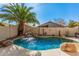 Inviting kidney-shaped pool with waterfall feature in a landscaped backyard at 10103 E Olla Ave, Mesa, AZ 85212