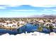 Aerial shot of waterfront homes, a community lake, and mountain views at 10113 E Topaz Dr, Scottsdale, AZ 85258