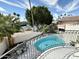 Relaxing balcony view of a clear pool and tennis courts under a vibrant sky at 10113 E Topaz Dr, Scottsdale, AZ 85258