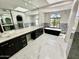 Bright bathroom with marble countertops, a standalone tub, and arched windows at 10113 E Topaz Dr, Scottsdale, AZ 85258