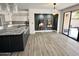 Open dining area next to a kitchen, featuring stylish decor, wooden floors, and sliding glass doors at 10113 E Topaz Dr, Scottsdale, AZ 85258