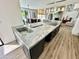 Kitchen island with stone countertop, cooktop, sink, and views to the living room at 10113 E Topaz Dr, Scottsdale, AZ 85258