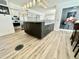 Well-appointed kitchen island, complemented by a large stainless steel refrigerator and white cabinetry at 10113 E Topaz Dr, Scottsdale, AZ 85258