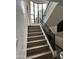 Grand staircase with wrought iron railing, bathed in natural light from a large window at 10113 E Topaz Dr, Scottsdale, AZ 85258