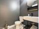 Modern powder room with dark gray walls and geometric floor at 1132 W 21St Ave, Apache Junction, AZ 85120