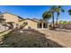 Backyard view of home with grassy area and block wall at 1133 E Dust Devil Dr, San Tan Valley, AZ 85143