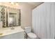 Bathroom with shower/tub combo and mosaic-tiled mirror at 1133 E Dust Devil Dr, San Tan Valley, AZ 85143