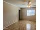 Neutral bedroom with tiled floor, ceiling fan, and bright window at 1133 E Dust Devil Dr, San Tan Valley, AZ 85143