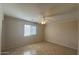 Calm bedroom with tiled floor, ceiling fan, and ample natural light from the window at 1133 E Dust Devil Dr, San Tan Valley, AZ 85143