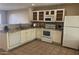 Well-lit kitchen with white appliances, granite countertops, and tiled backsplash at 1133 E Dust Devil Dr, San Tan Valley, AZ 85143