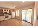 Bright kitchen with ample counter space, white appliances, and sliding glass doors to the backyard at 1133 E Dust Devil Dr, San Tan Valley, AZ 85143