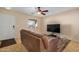 Living room with a brown couch and large TV at 1133 E Dust Devil Dr, San Tan Valley, AZ 85143