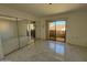 Main bedroom with mirrored closet and access to balcony at 12221 W Bell Rd # 363, Surprise, AZ 85378