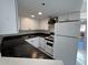 Clean galley kitchen with white cabinets and dark countertops at 12221 W Bell Rd # 363, Surprise, AZ 85378