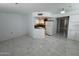 Bright living room and kitchen featuring white cabinetry and marble floors at 12221 W Bell Rd # 363, Surprise, AZ 85378