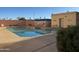 Community pool with surrounding patio and building at 12221 W Bell Rd # 363, Surprise, AZ 85378