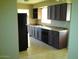 Galley kitchen with dark wood cabinets and tile floor at 1340 E Crescent Ave, Mesa, AZ 85204