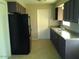 View of galley kitchen with dark wood cabinets at 1340 E Crescent Ave, Mesa, AZ 85204