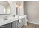 Modern bathroom with dual sinks and gray cabinets at 13859 N 91St Ln, Peoria, AZ 85381