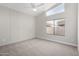 Bright bedroom featuring new carpet, large window, and neutral wall paint at 13859 N 91St Ln, Peoria, AZ 85381