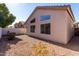 Tan colored house with backyard and gravel landscaping at 13859 N 91St Ln, Peoria, AZ 85381