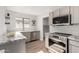 Modern kitchen featuring granite countertops, stainless steel appliances, and L-shaped design at 13859 N 91St Ln, Peoria, AZ 85381