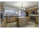 Open kitchen with granite counters and wood cabinets at 147 S Los Cielos Ln, Casa Grande, AZ 85194