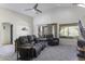 Open living room featuring a ceiling fan, vaulted ceiling, and sliding glass doors at 147 S Los Cielos Ln, Casa Grande, AZ 85194