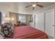 Bright bedroom with red and white bedding and lots of closet space at 15220 W Blue Verde Dr, Sun City West, AZ 85375