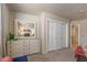 Bedroom with white dresser, large mirror and double door closet at 15220 W Blue Verde Dr, Sun City West, AZ 85375