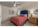 Guest bedroom with red and white bedding and ceiling fan at 15220 W Blue Verde Dr, Sun City West, AZ 85375