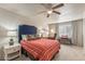 Cozy bedroom with striped bedding, and a ceiling fan at 15220 W Blue Verde Dr, Sun City West, AZ 85375