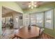 Bright dining area with wood table and view into sunroom at 15220 W Blue Verde Dr, Sun City West, AZ 85375