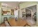 Kitchen dining area with wood table and view into living room at 15220 W Blue Verde Dr, Sun City West, AZ 85375