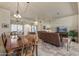 Sunlit dining room with a large wooden table and comfortable seating at 15220 W Blue Verde Dr, Sun City West, AZ 85375