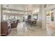 Open dining room with a wooden table and chairs, adjacent to a living area at 15220 W Blue Verde Dr, Sun City West, AZ 85375