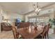 Elegant dining room with a wood table and chairs, adjacent to the living room at 15220 W Blue Verde Dr, Sun City West, AZ 85375