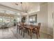 Bright dining room with a wooden table and chairs, looking toward the living room at 15220 W Blue Verde Dr, Sun City West, AZ 85375