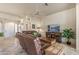 Comfortable living room with brown leather recliners, a TV, and access to entryway at 15220 W Blue Verde Dr, Sun City West, AZ 85375