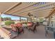 Relaxing covered patio with seating area and ceiling fans at 15220 W Blue Verde Dr, Sun City West, AZ 85375