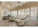 Bright sunroom with comfy seating and plantation shutters, overlooking a scenic view at 15220 W Blue Verde Dr, Sun City West, AZ 85375