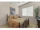 Cozy bedroom with a queen-size bed and large window with blinds at 15240 N 142Nd Ave # 2159, Surprise, AZ 85379