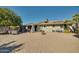 Backyard view showing home, patio, and mature fruit trees at 15489 N Ridgeview Rd, Sun City, AZ 85351