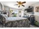 Main bedroom with large window, ceiling fan, and dresser at 15489 N Ridgeview Rd, Sun City, AZ 85351