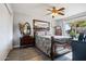 Bedroom with large window, ceiling fan, and ornate bed frame at 15489 N Ridgeview Rd, Sun City, AZ 85351