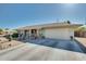 Ranch style home with a two car garage and desert landscaping at 15489 N Ridgeview Rd, Sun City, AZ 85351