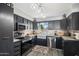 Updated kitchen with farmhouse sink and dark cabinetry at 15489 N Ridgeview Rd, Sun City, AZ 85351