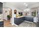 Modern kitchen with dark cabinetry and an island breakfast bar at 15489 N Ridgeview Rd, Sun City, AZ 85351