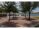 Brick patio area with gazebo overlooking a lake, featuring benches and trees at 15577 S 181St Ln, Goodyear, AZ 85338